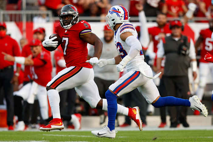 Tampa Bay Buccaneers running back Leonard Fournette (7) runs past Buffalo Bills safety Micah Hyde (23) in the first half at Raymond James Stadium.